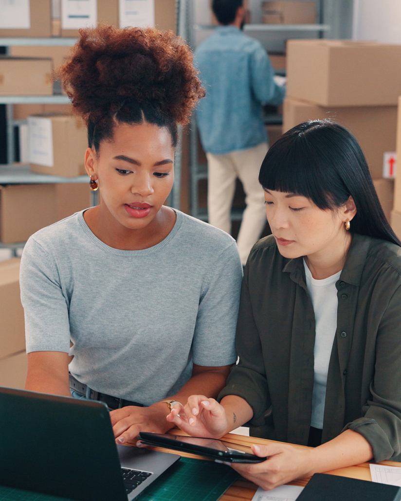 Colleagues Running Retail Warehouse Vertical