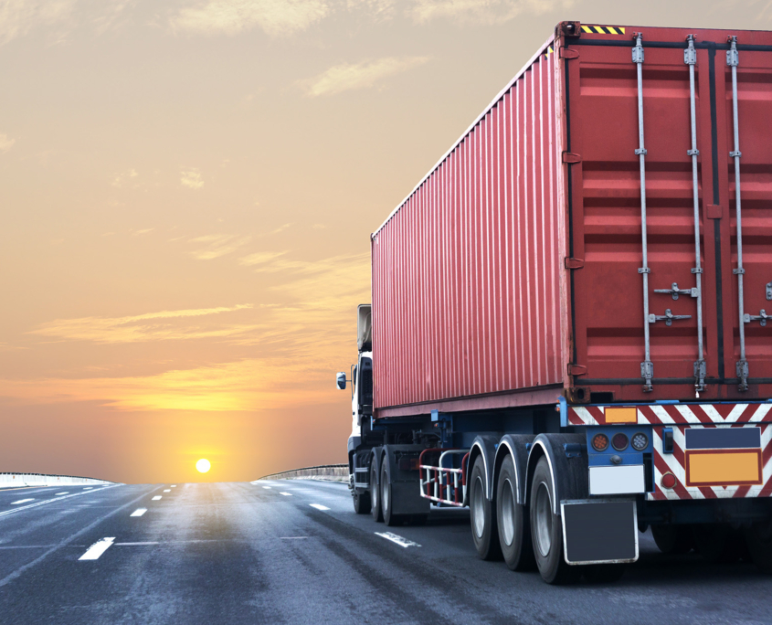 Truck With Shipping Container Driving On A Highway